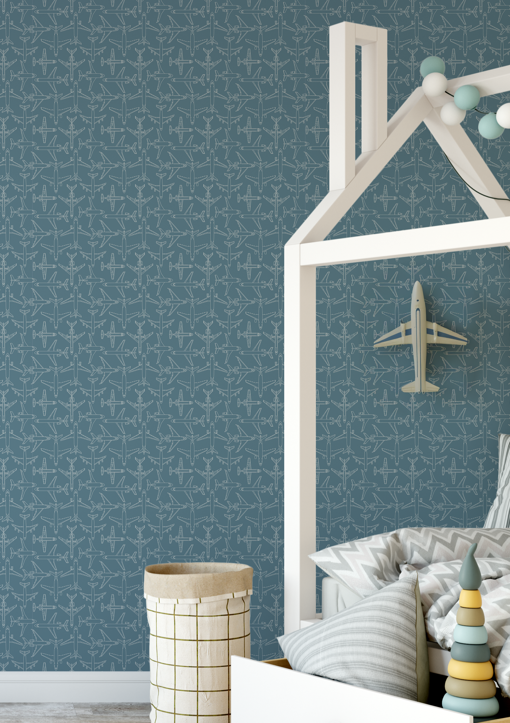 Blue airplane wallpaper in kids bedroom with house-frame bed and soft decor, aviation-themed nursery design