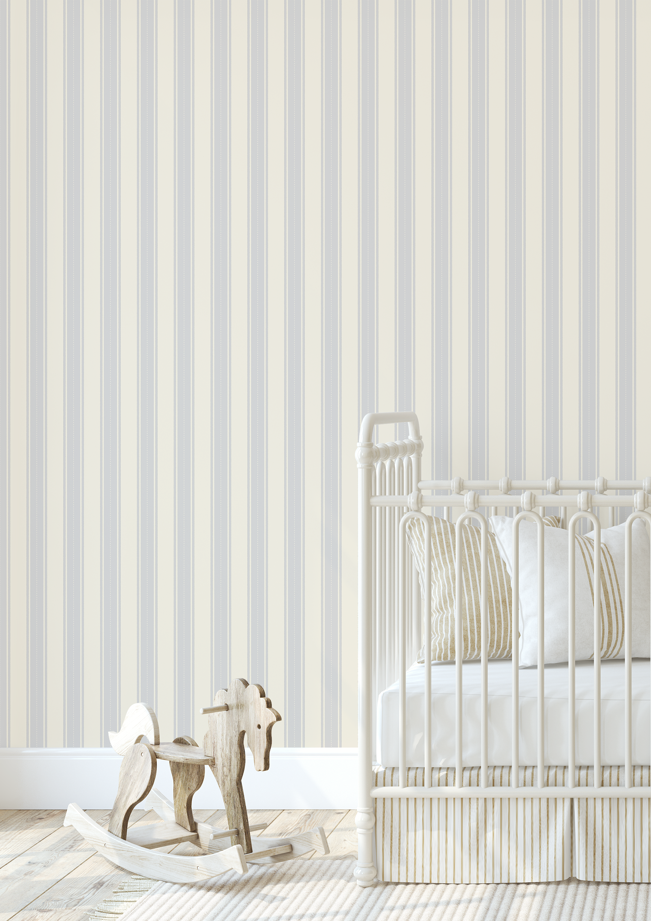 Blue dotted stripe wallpaper in a neutral baby nursery with cream crib, striped bedding, and wooden rocking horse, creating a cozy vintage style
