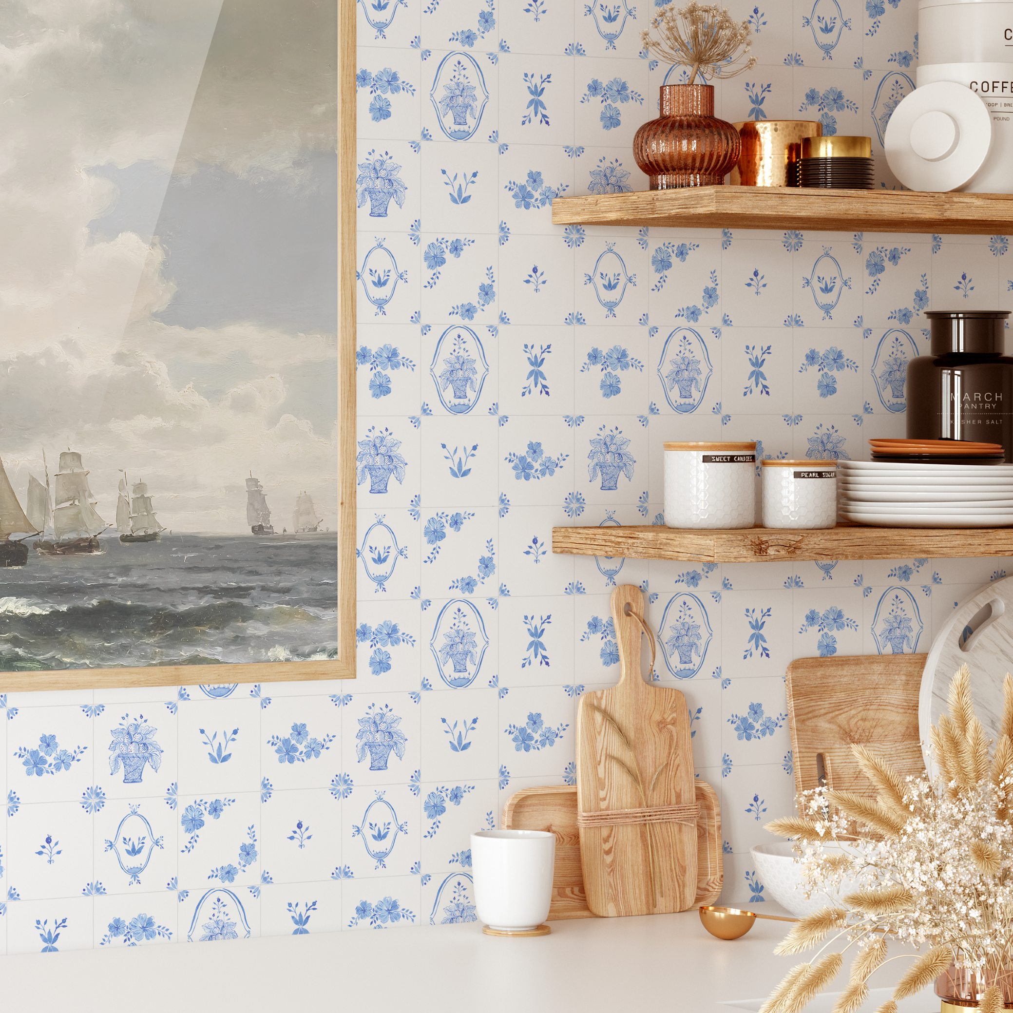 Blue and white Delft tile wallpaper in kitchen with wooden shelves and nautical artwork.