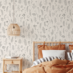 Bedroom with floral wallpaper, wooden bed, and bedside table.