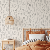 Bedroom with floral wallpaper, wooden bed, and bedside table.