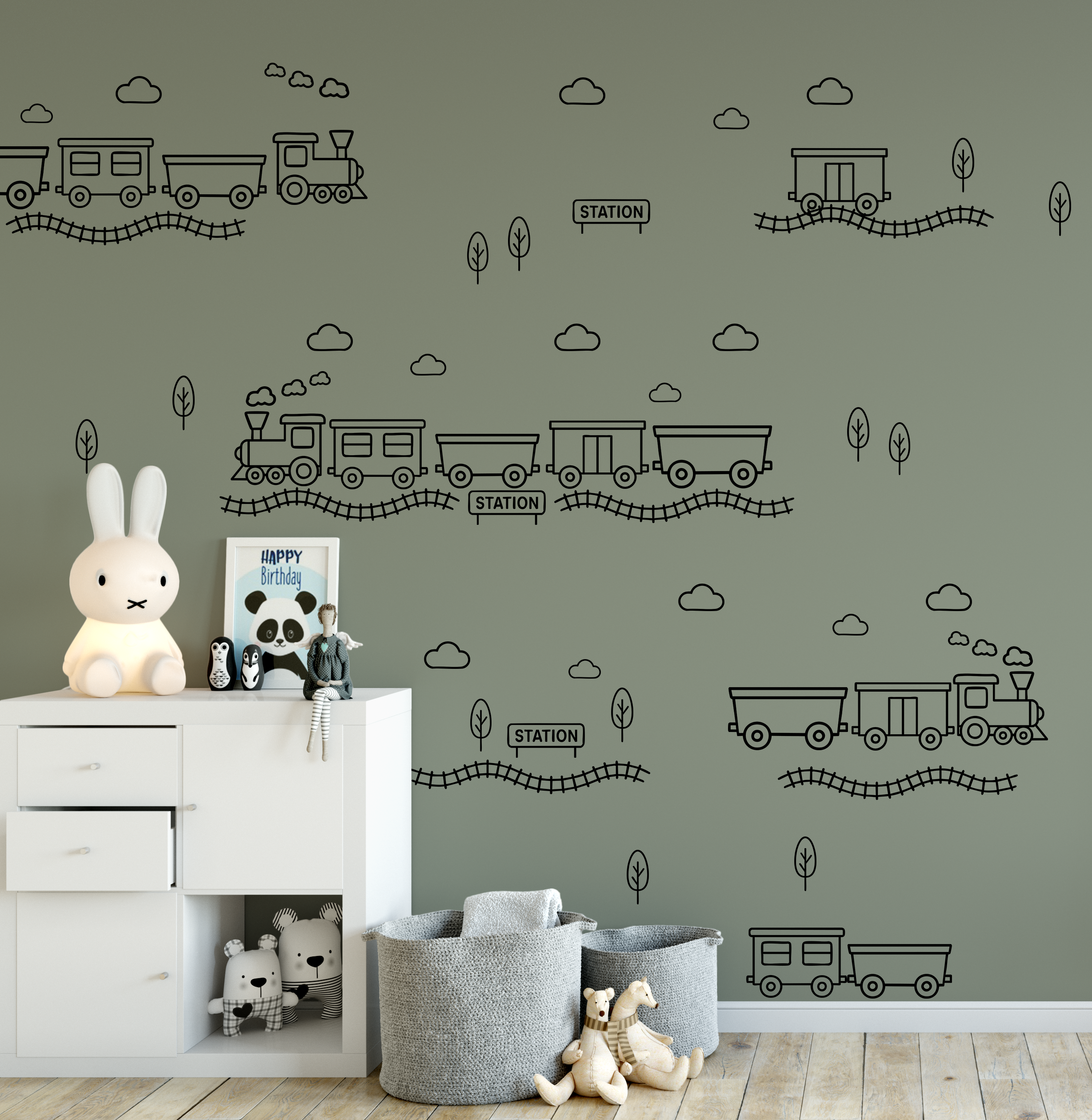 Green wall with black outline train decals in a nursery setting — train theme wall decor for boys bedroom