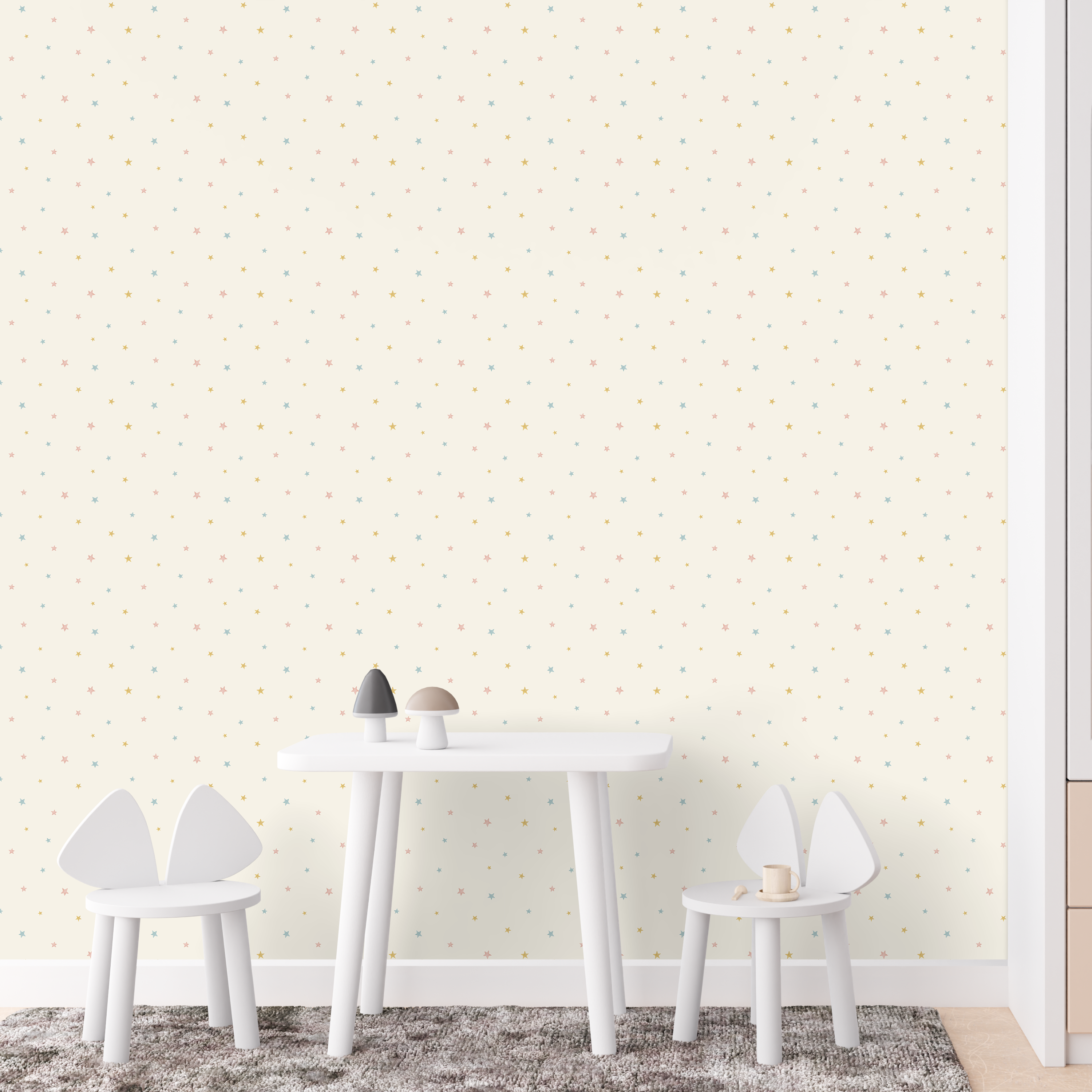 pastel star wallpaper in kids playroom with small pink blue and gold stars on cream background