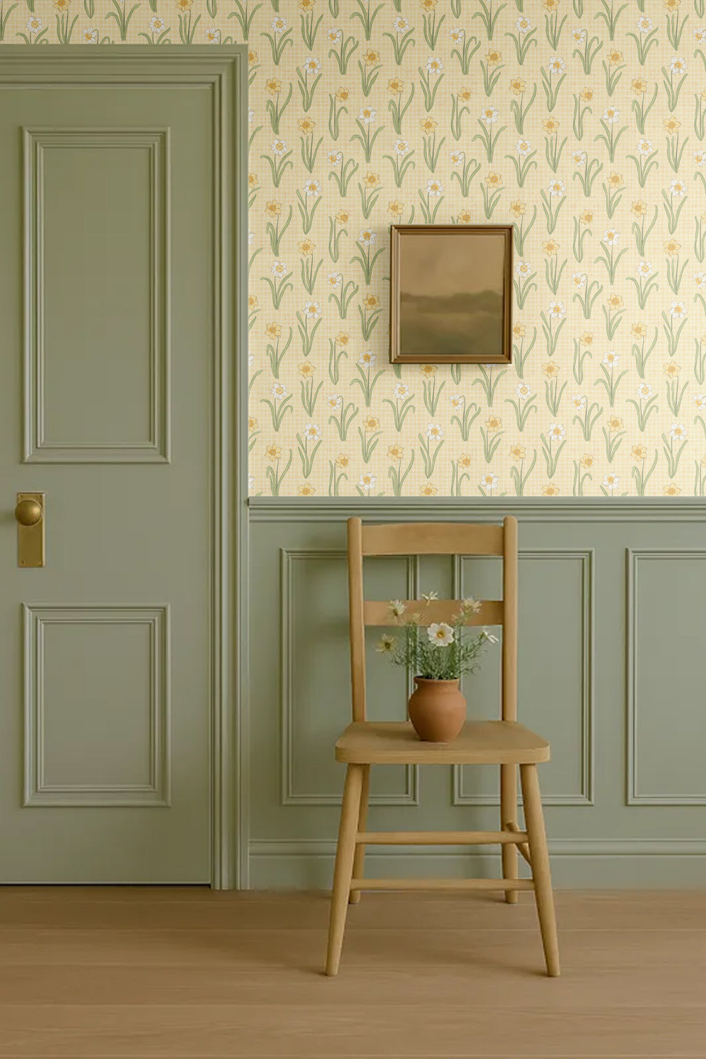 Muted green and yellow wallpaper with vintage chair and panel moulding