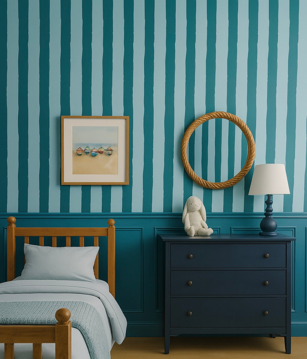 Kids bedroom with bold blue and light blue vertical stripe wallpaper and nautical decor