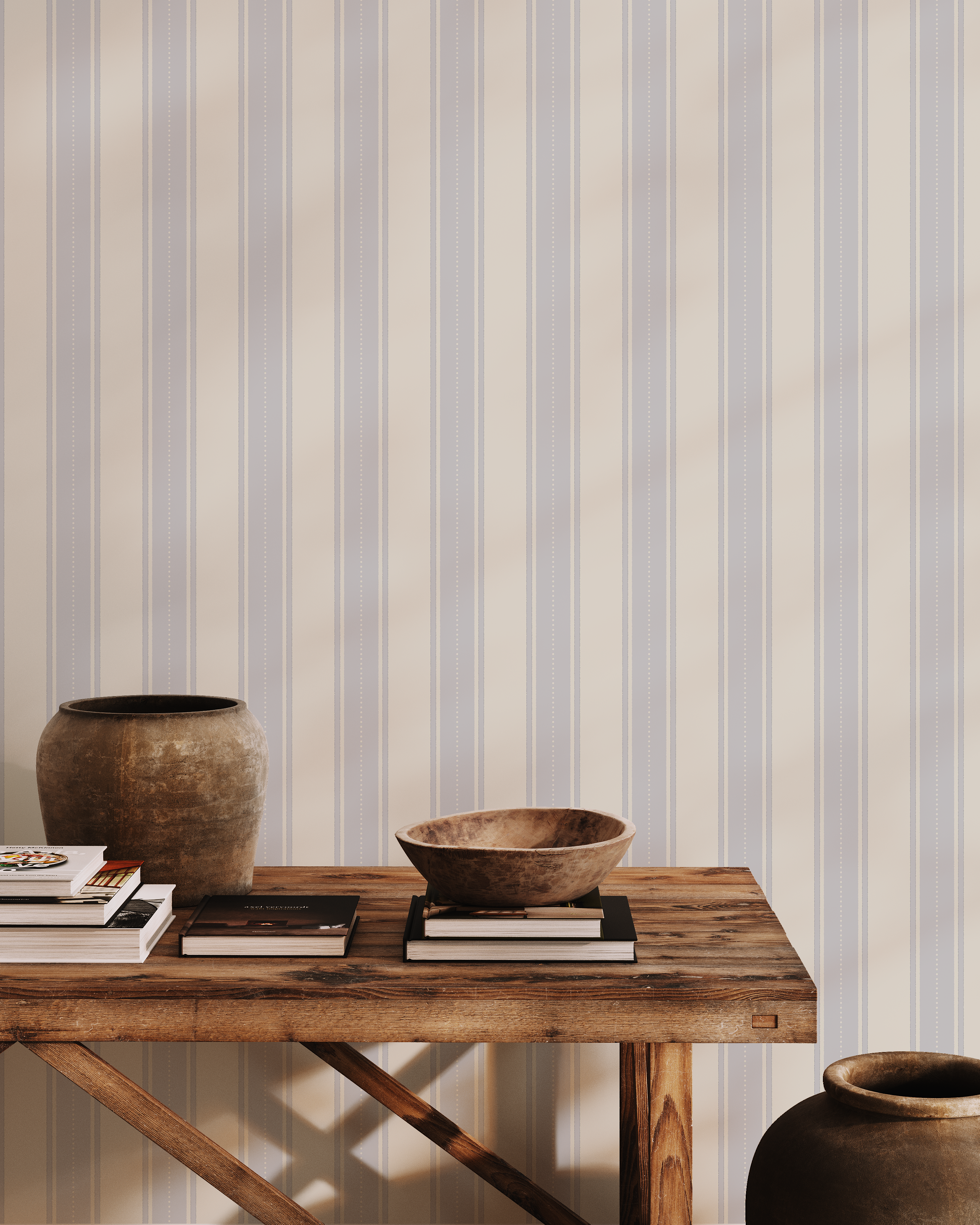 Vintage-inspired blue and cream striped wallpaper styled with rustic wood console table, ceramic vases, and natural decor for a timeless coastal look