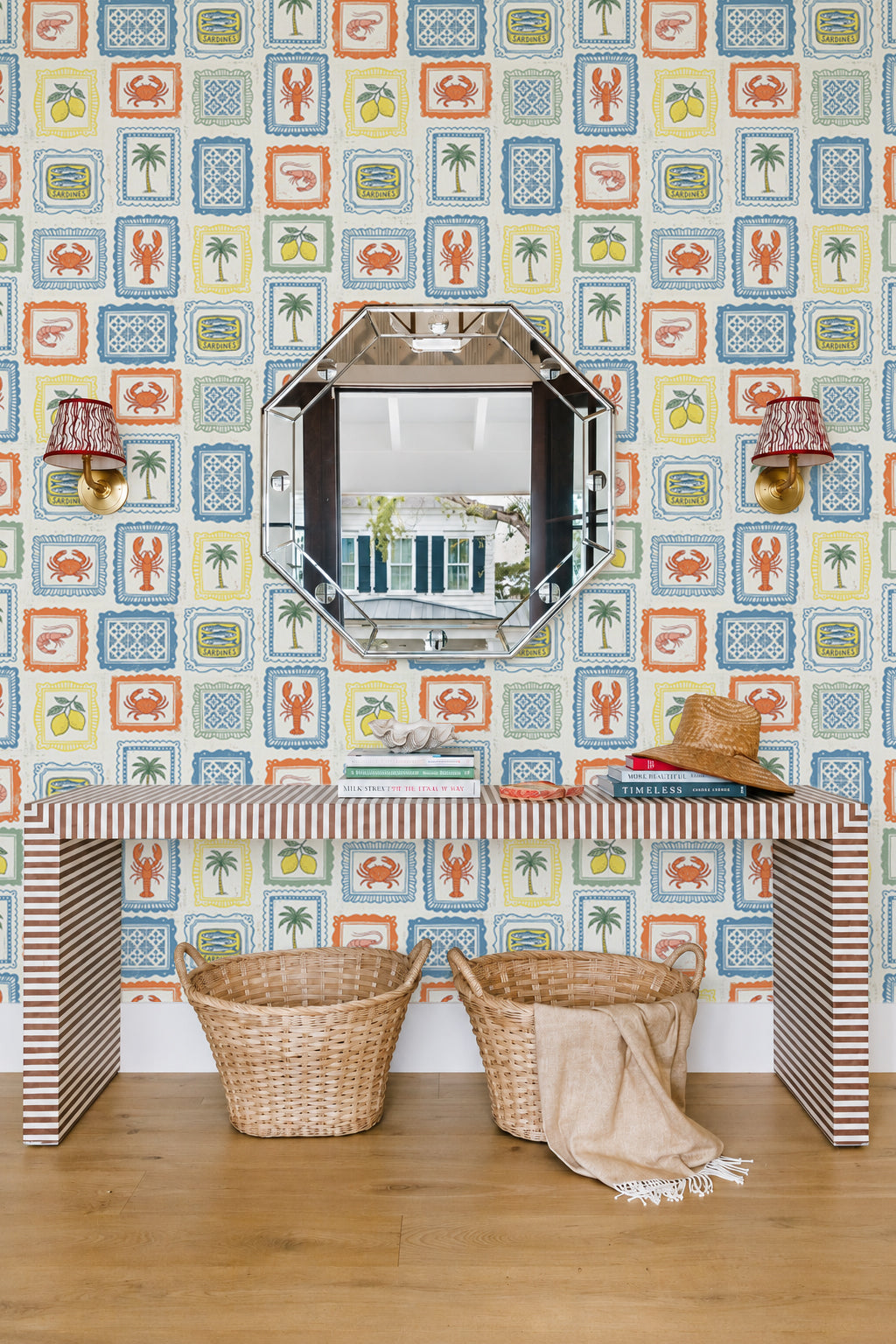 Coastal Market Mediterranean style Room interior with patterned wallpaper, striped table, and wicker baskets.