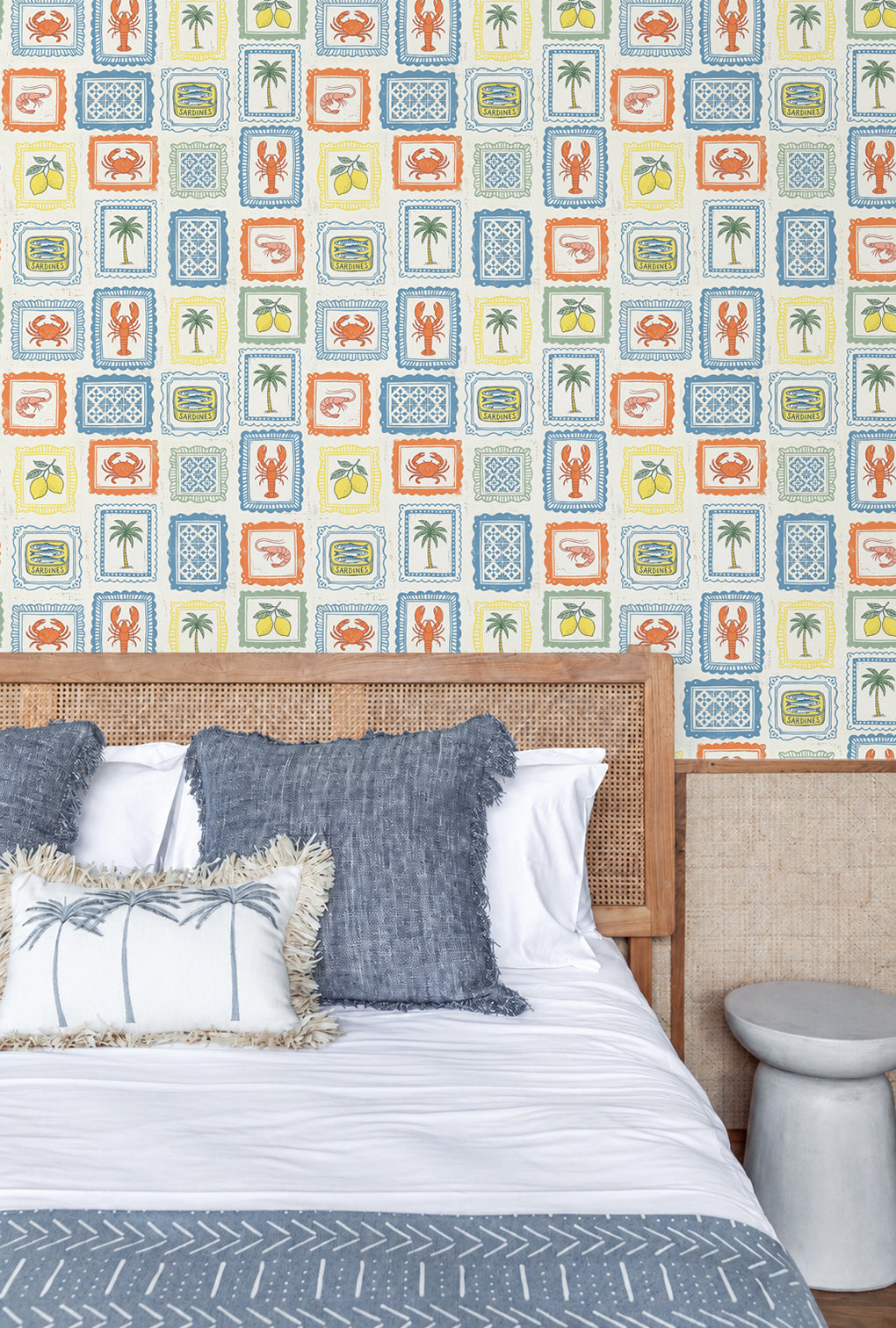 Bedroom with a Mediterranean patterned wallpaper featuring crabs, palm trees, and cars.
