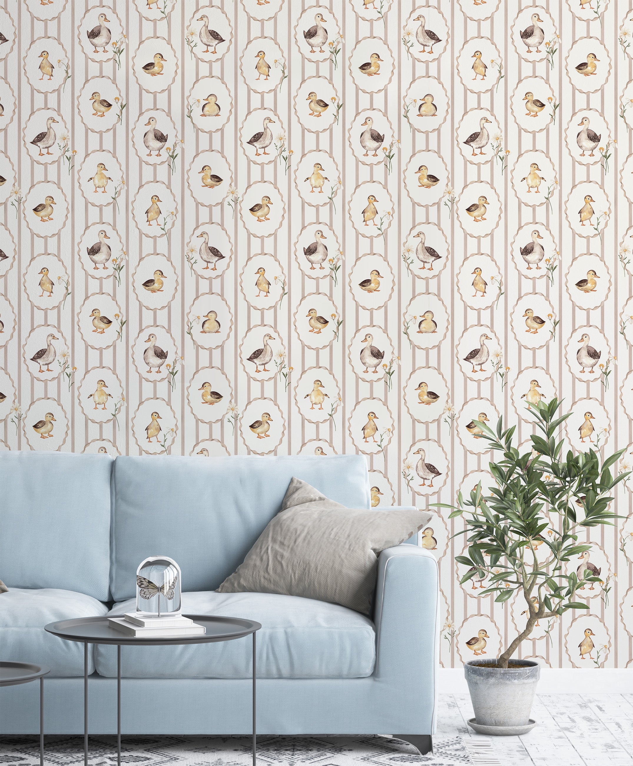 Living room with light blue sofa, decorative plant, and wallpaper featuring bird patterns.