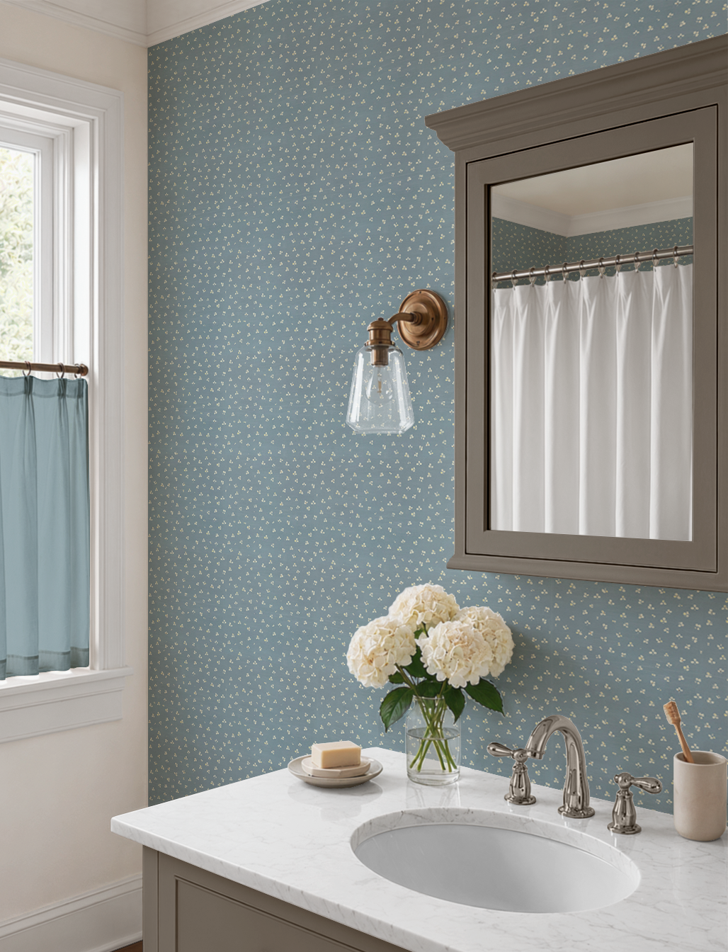Blue Forget Me Not wallpaper in a bright bathroom featuring a marble vanity, brushed nickel fixtures, and vintage floral pattern.