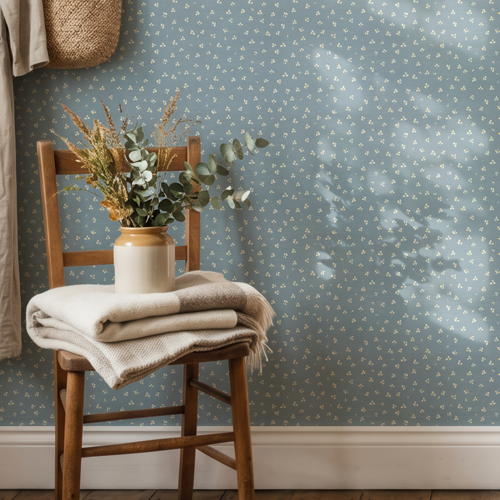 Forget Me Not floral wallpaper with tiny blue ditsy flowers in a cozy cottage style entryway with wooden chair and neutral decor.