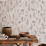 Wallpaper with simple floral pattern, wooden table with decorative items, and vases. French Cottage Decor.