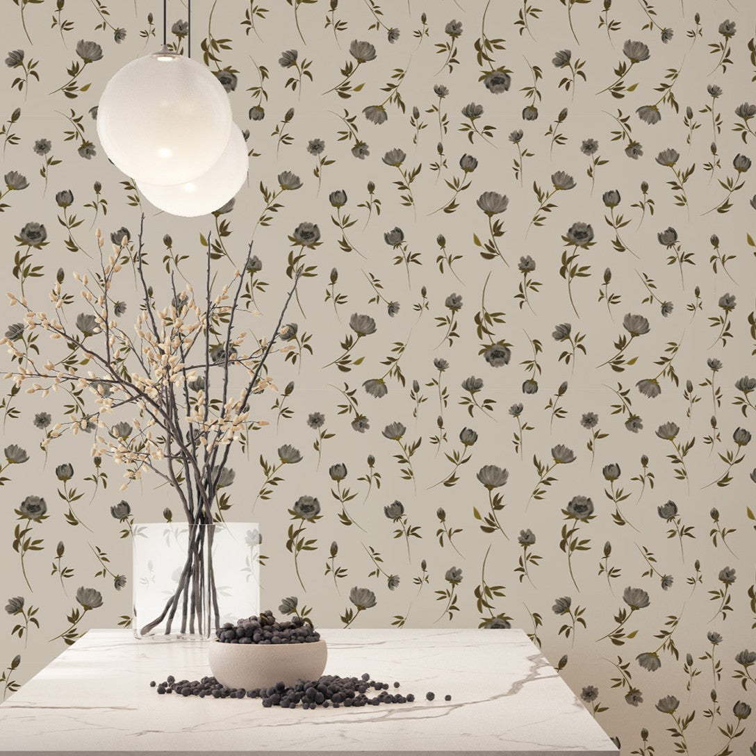 Decorative wall with floral pattern, table with vase and branches, and hanging light fixture.