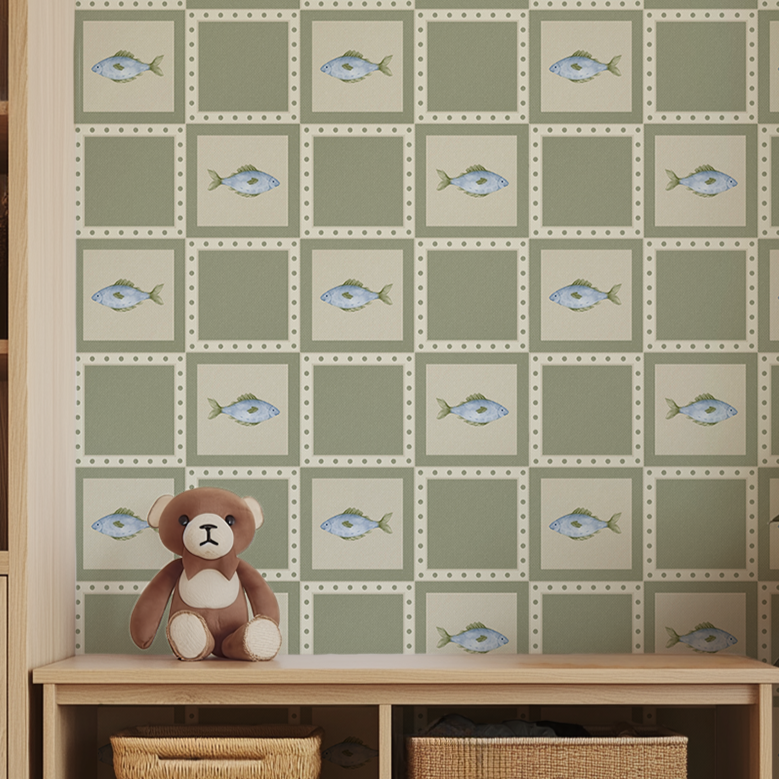 Gone Fishing wallpaper with blue fish and sage green quilt pattern behind a wooden storage bench with teddy bear and wicker baskets.