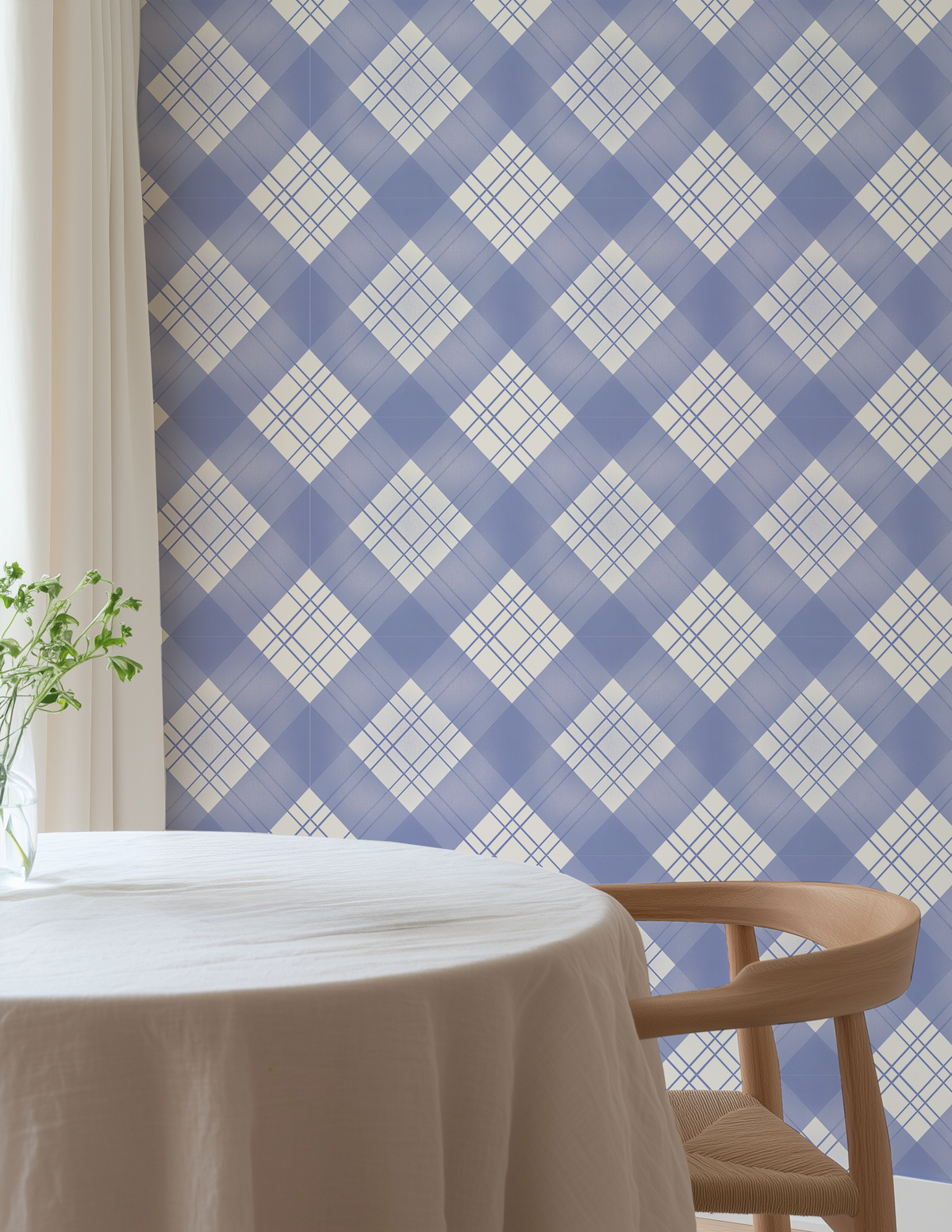 Periwinkle blue plaid wallpaper in a bright dining nook with natural wood chair, white tablecloth and soft neutral decor.