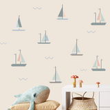 Nursery with neutral sailboat wall decals and plush whale decor