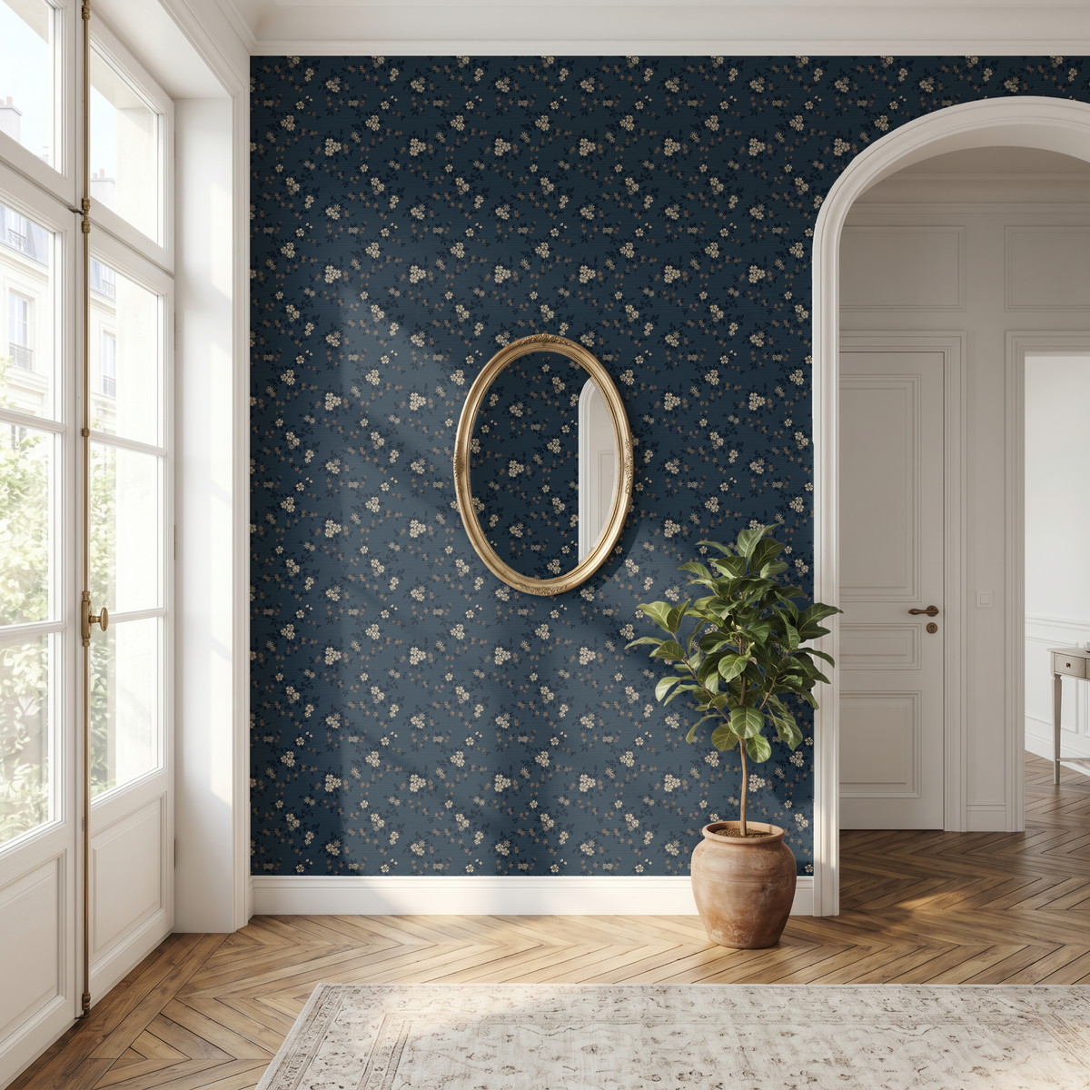 Navy botanical floral wallpaper in a bright traditional hallway with arched doorway, gold mirror and warm wood floors
