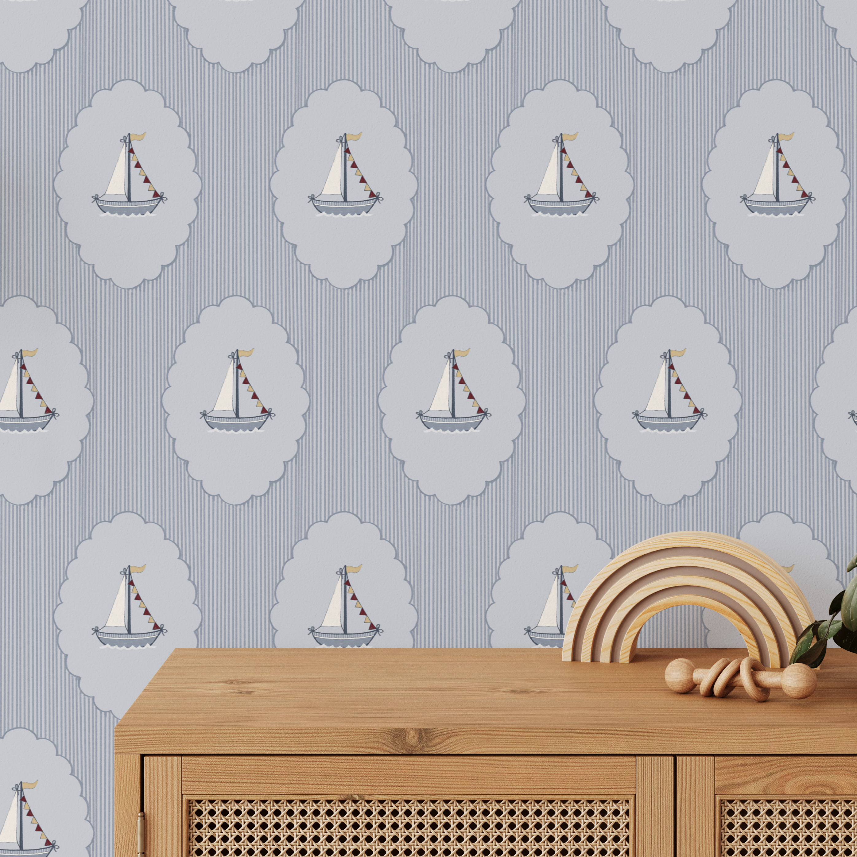 Blue nautical sailboat wallpaper in nursery with scalloped medallions and striped background, coastal kids room decor
