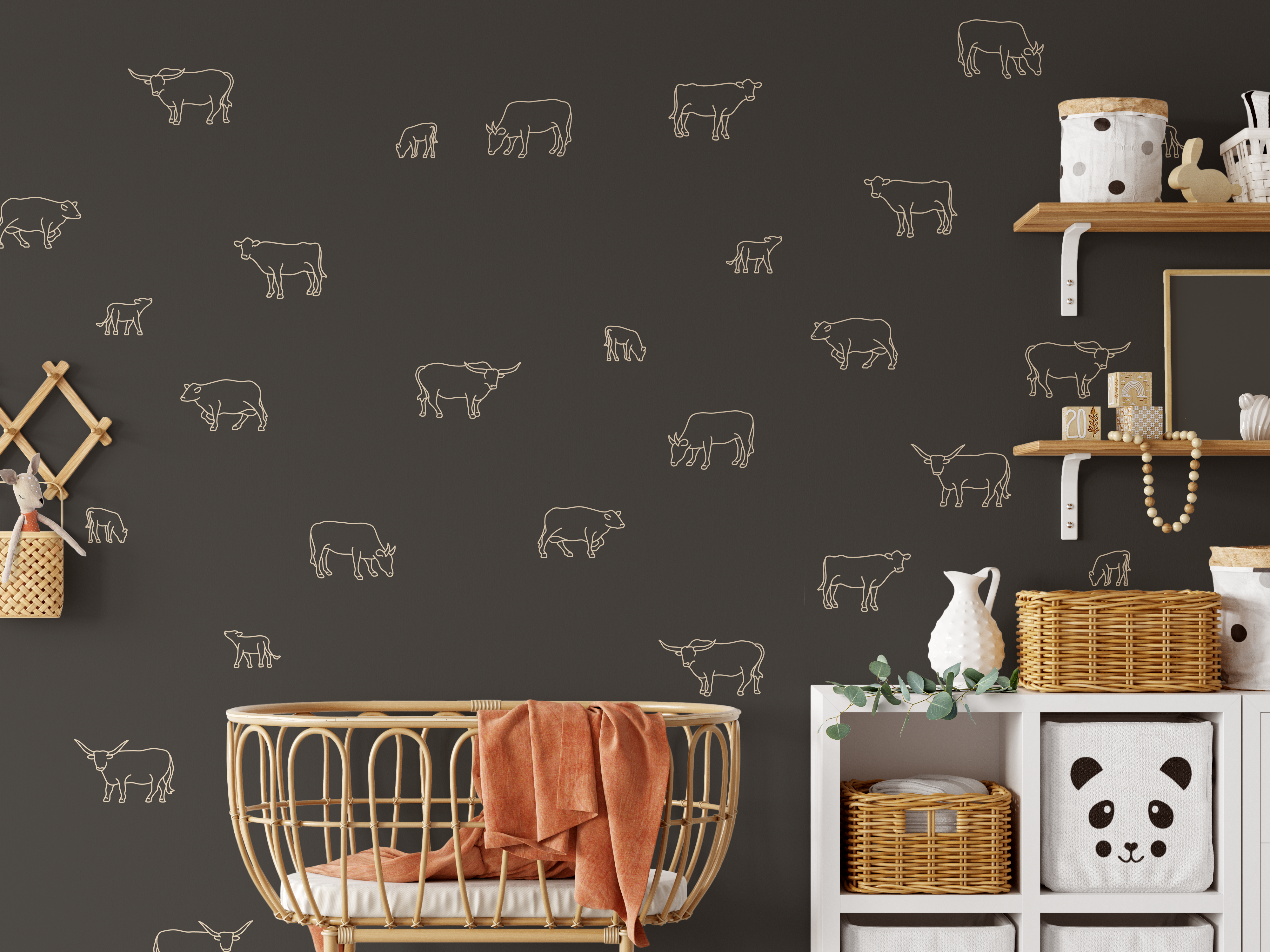 Cow decals in warm beige outline on dark nursery wall with rattan crib and shelves