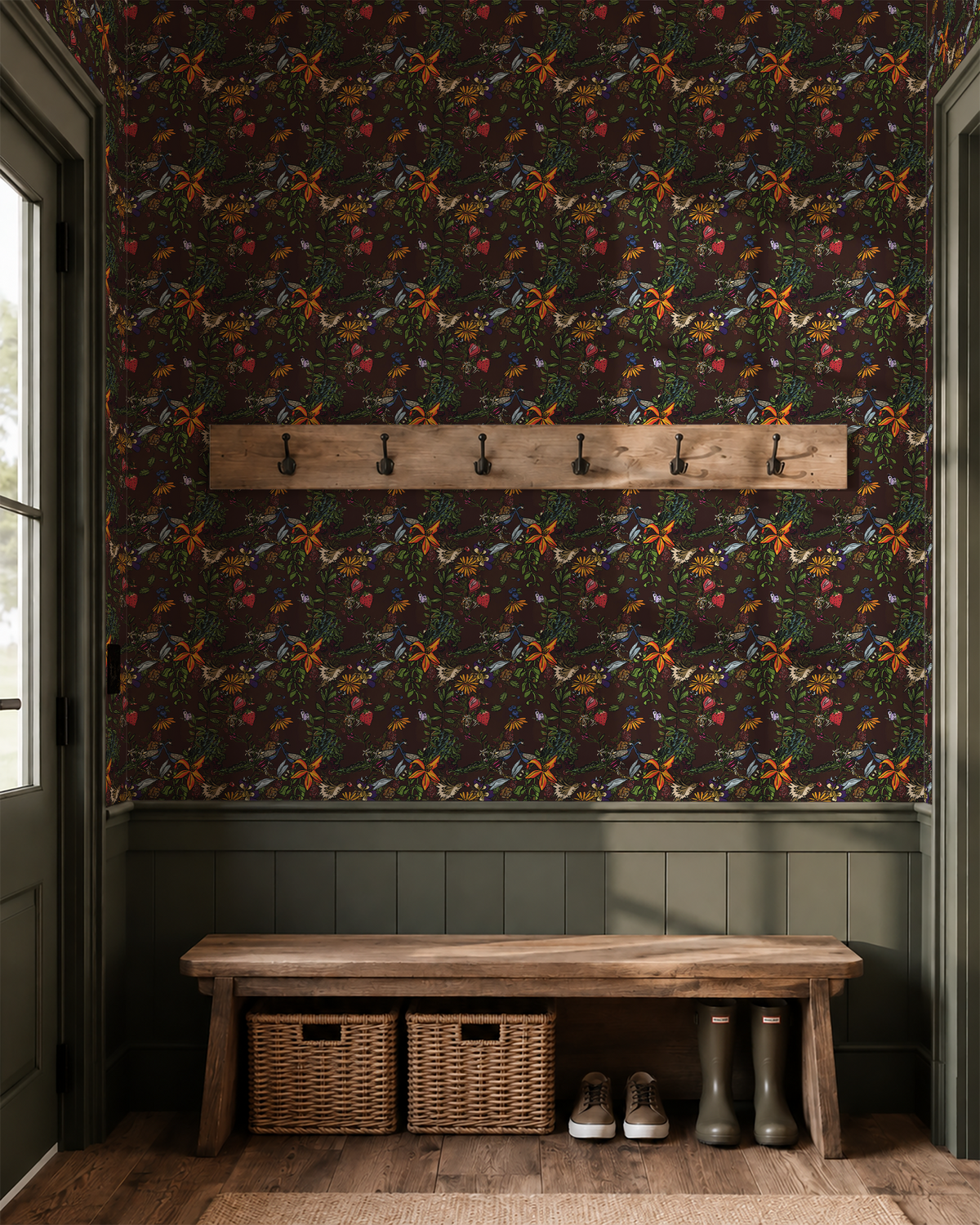 Dark brown peacock wallpaper with vibrant flowers, birds and greenery above olive green wainscoting in a rustic mudroom with wooden bench.
