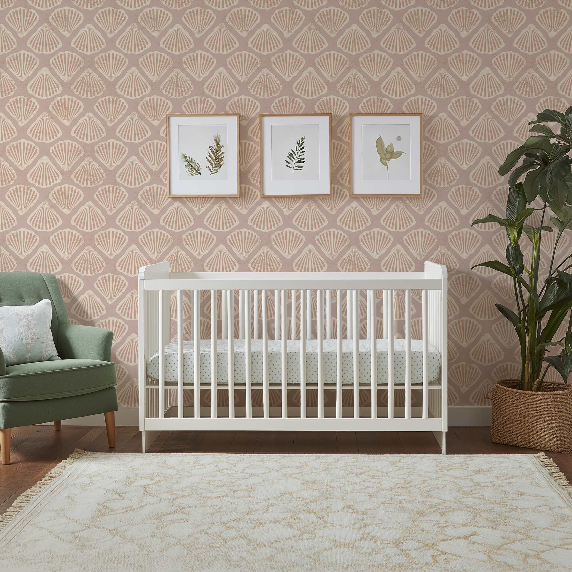 Sandy scallop shell wallpaper styled in a coastal nursery with white crib