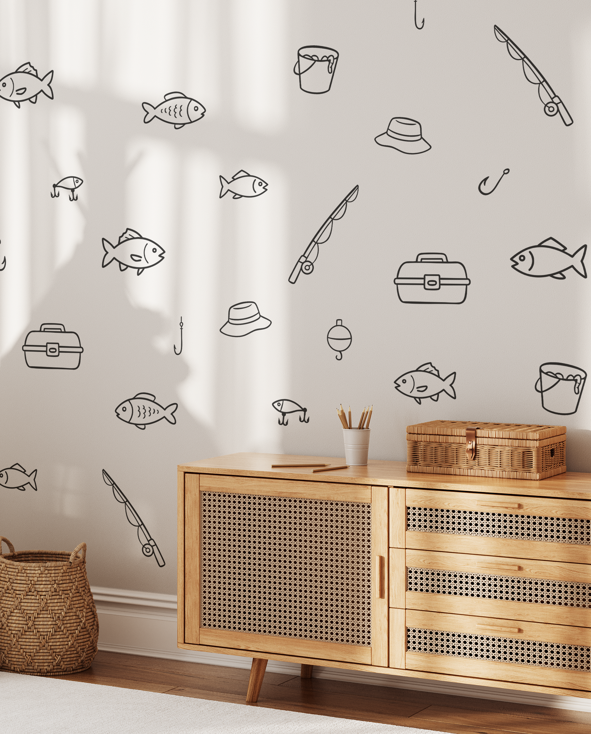 Fishing decals on white wall above wicker cabinet, minimalist fish and fishing gear wall decals for lake house or cabin wall art.