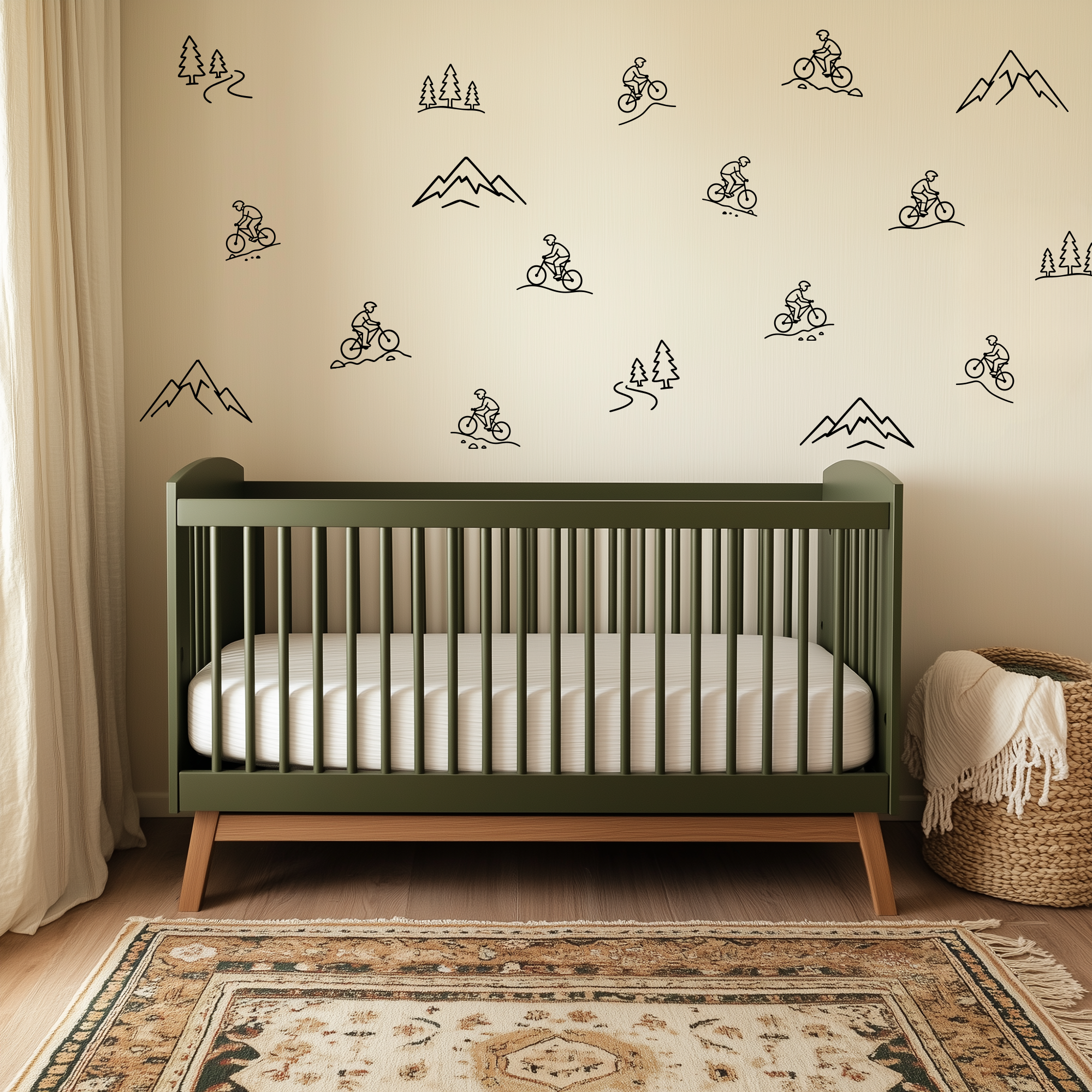 Mountain bike nursery wall decals decorating a green crib nursery with minimalist biking, mountain, and forest outline stickers.