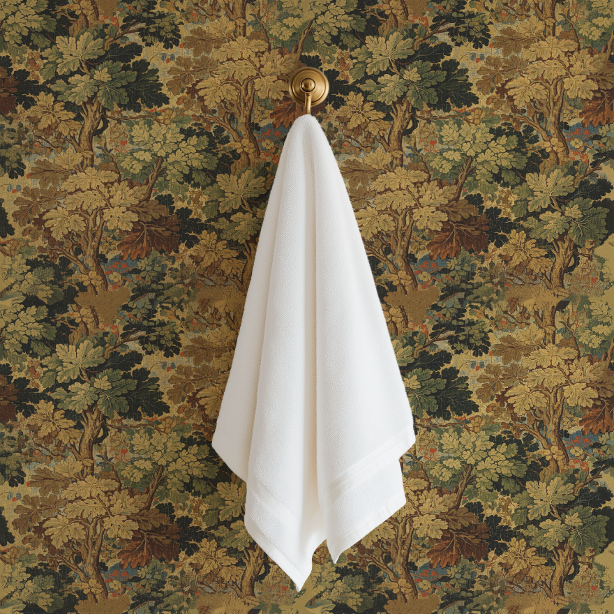 Tapestry peel and stick wallpaper styled in a bathroom with a white towel and brass wall hook.