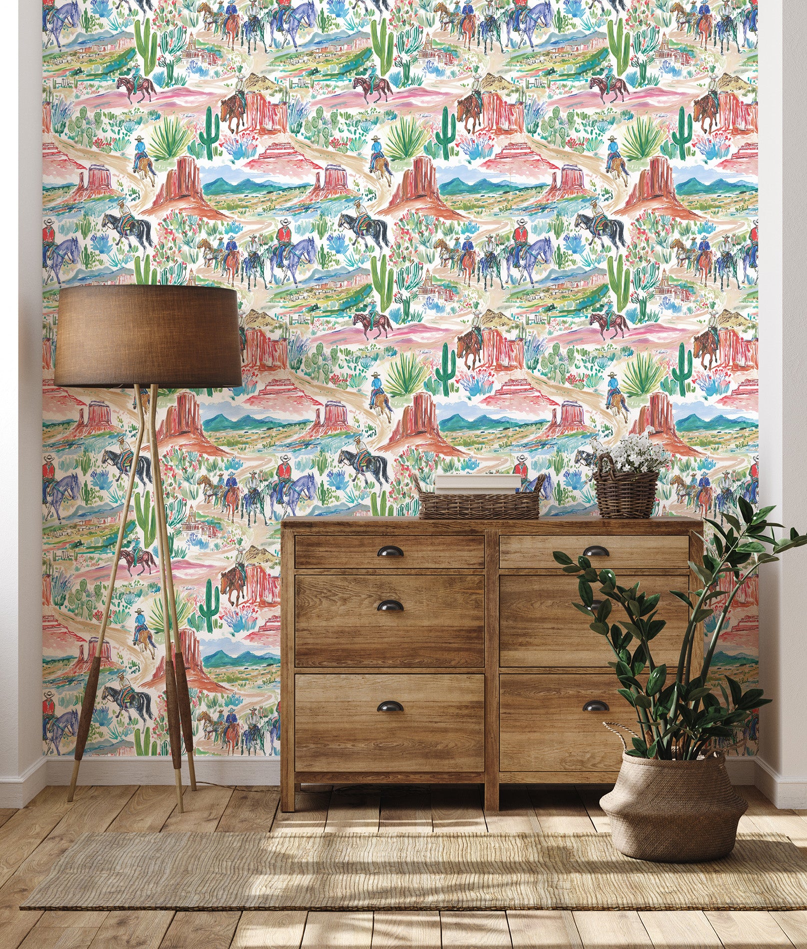 Western painted landscape wallpaper installed in entryway with wooden dresser and neutral decor featuring cowboys, horses, and desert mesas