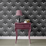 A modern room featuring black heron-patterned wallpaper, with a bold pink console table and a lamp, creating a striking contrast.