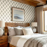Rustic bedroom adorned with elegant blue floral wallpaper, cozy bedding, and natural textures for a timeless look