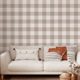 Neutral brown gingham wallpaper in cozy living room with cream sofa and accent pillows