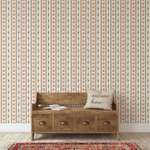 Neutral Western-themed wallpaper with cacti and horseshoes, styled in a classic entryway