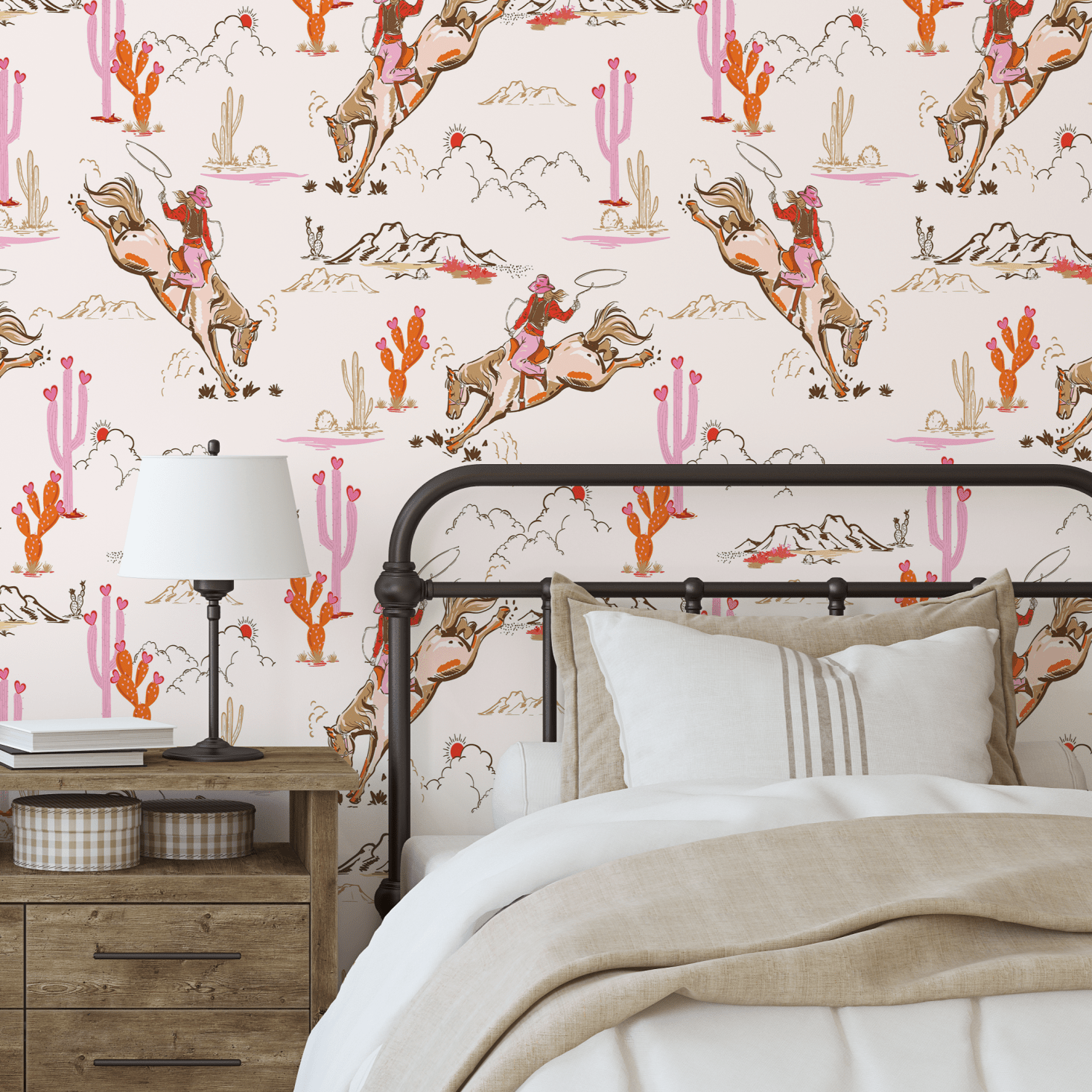 Cozy bedroom with a single bed against a Coral Rodeo wallpaper accent wall, designed with cowgirl and desert motifs in pink and coral hues