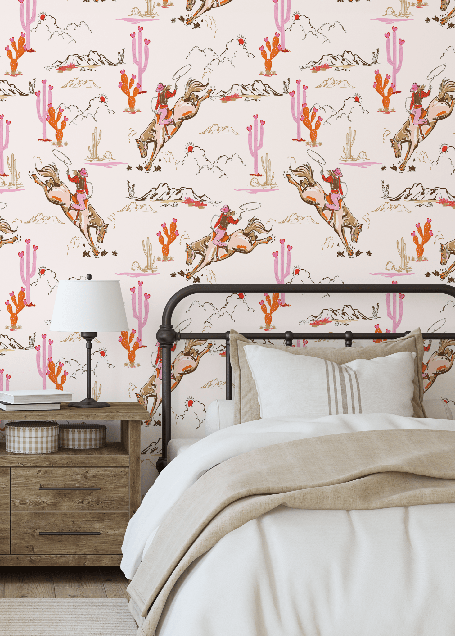 Cozy bedroom with a single bed against a Coral Rodeo wallpaper accent wall, designed with cowgirl and desert motifs in pink and coral hues