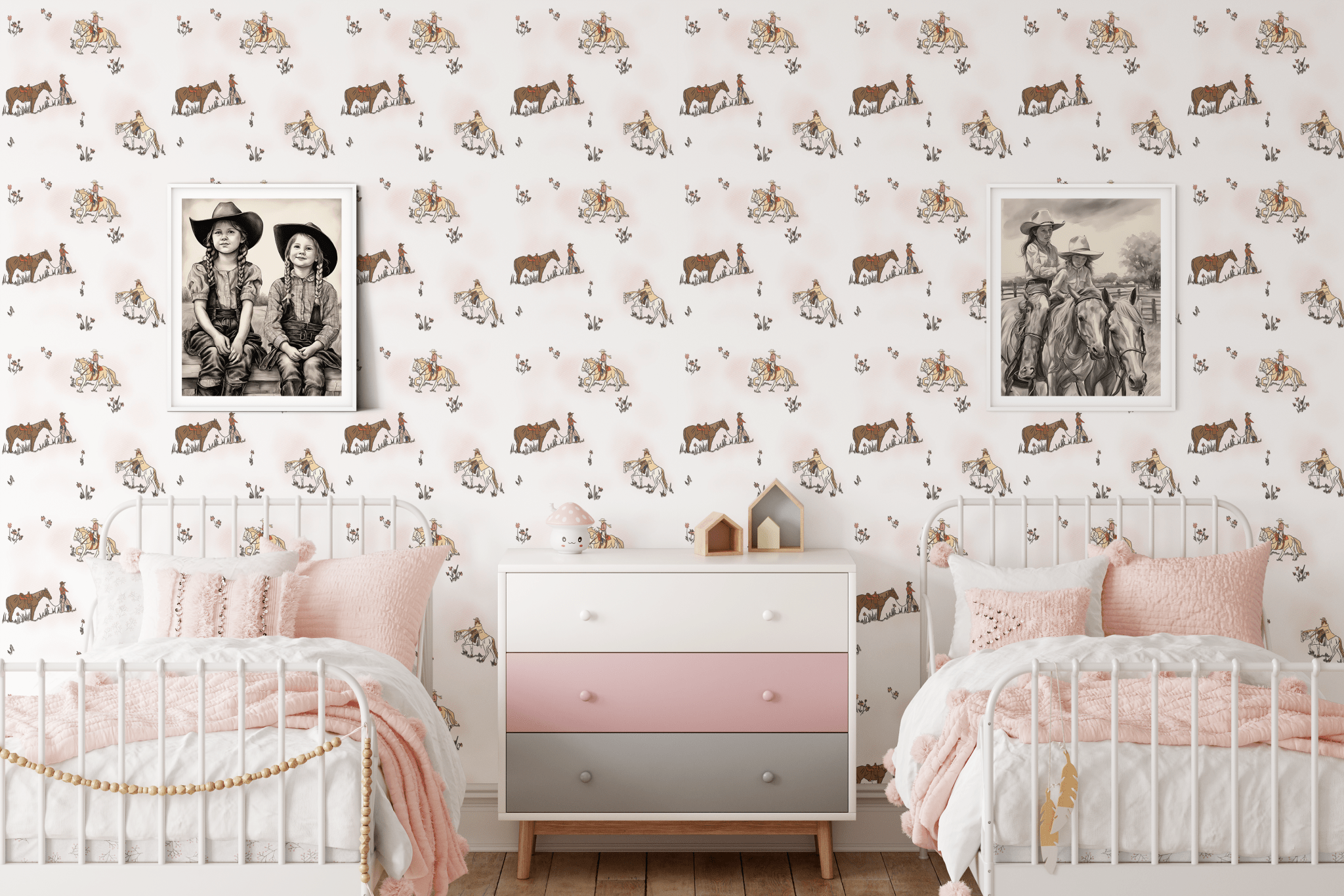 A shared bedroom setup featuring two white metal beds with pink bedding, a pastel-colored dresser, and cowgirl-themed wallpaper decorated with scenes of cowgirls and horses, creating a playful and inviting atmosphere.