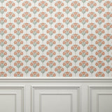 Close-up view of floral damask wallpaper showcasing intricate orange and green floral patterns.