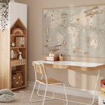 A beautifully designed children's room featuring a desk, a shelf with toys, and a large removable world map wall decal with vintage airplanes and hot air balloons. The decal adds a charming educational touch to the decor.