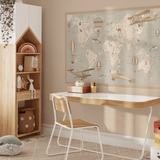 A beautifully designed children's room featuring a desk, a shelf with toys, and a large removable world map wall decal with vintage airplanes and hot air balloons. The decal adds a charming educational touch to the decor.