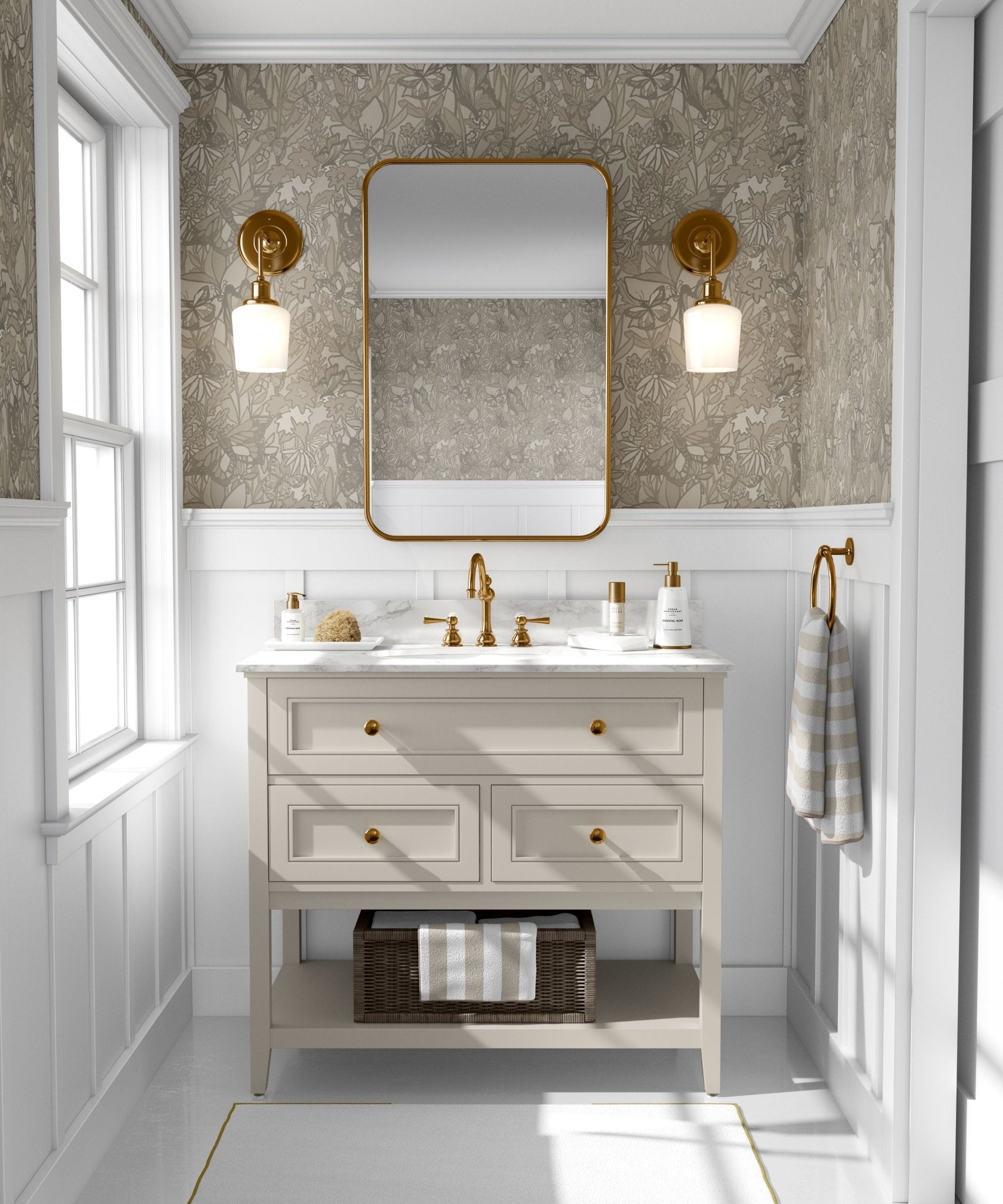 A stylish bathroom with walls covered in a neutral-toned butterfly and floral wallpaper. The decor includes a white vanity with gold handles, a white marble top, and brass fixtures.
