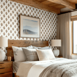 Bright bedroom featuring floral wallpaper and soft linens.