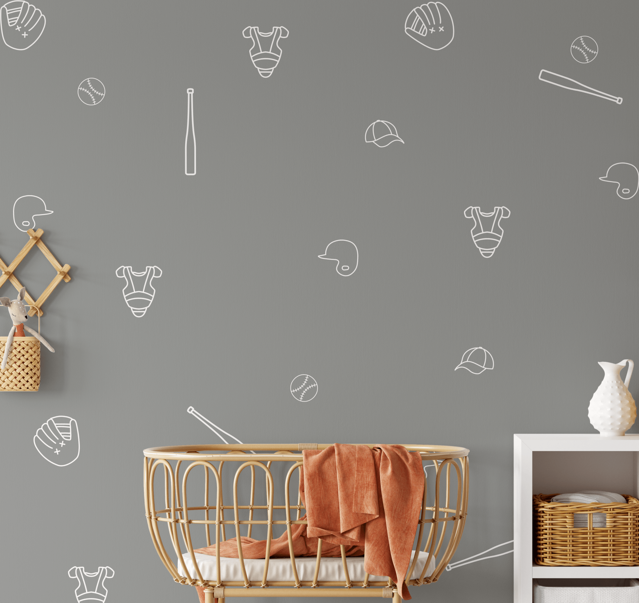 Baseball outline decals on a grey wall in a stylish nursery setup, with bat, glove, and ball designs in white.