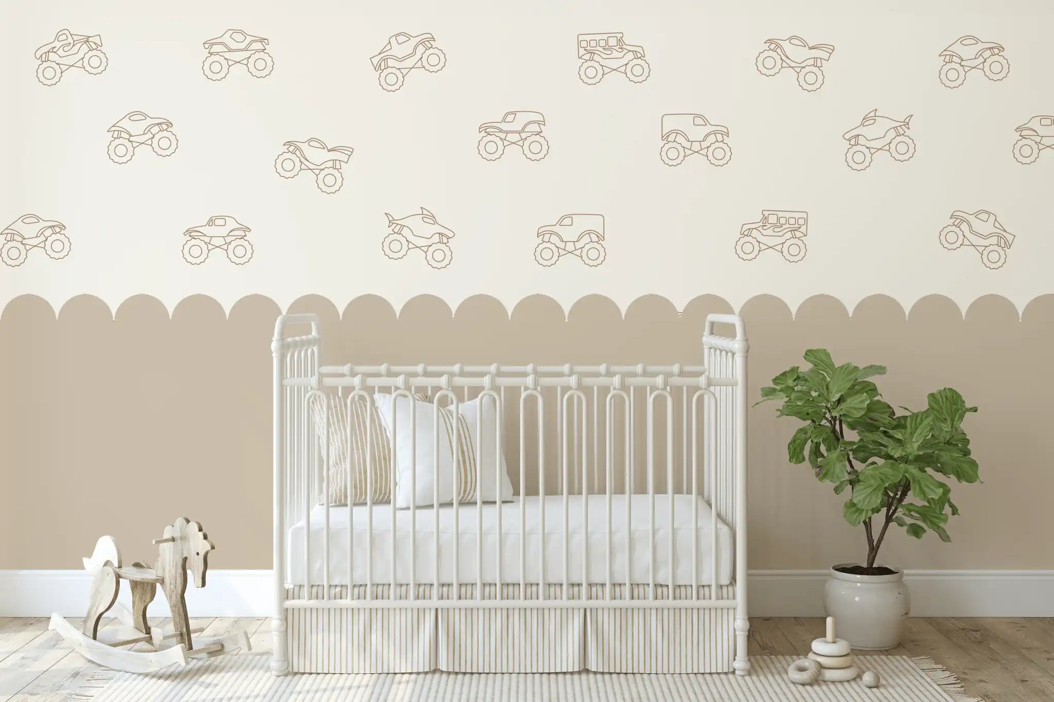 Outline-style monster truck decals in brown on a beige and white scalloped wall above a white crib and a wooden rocking horse