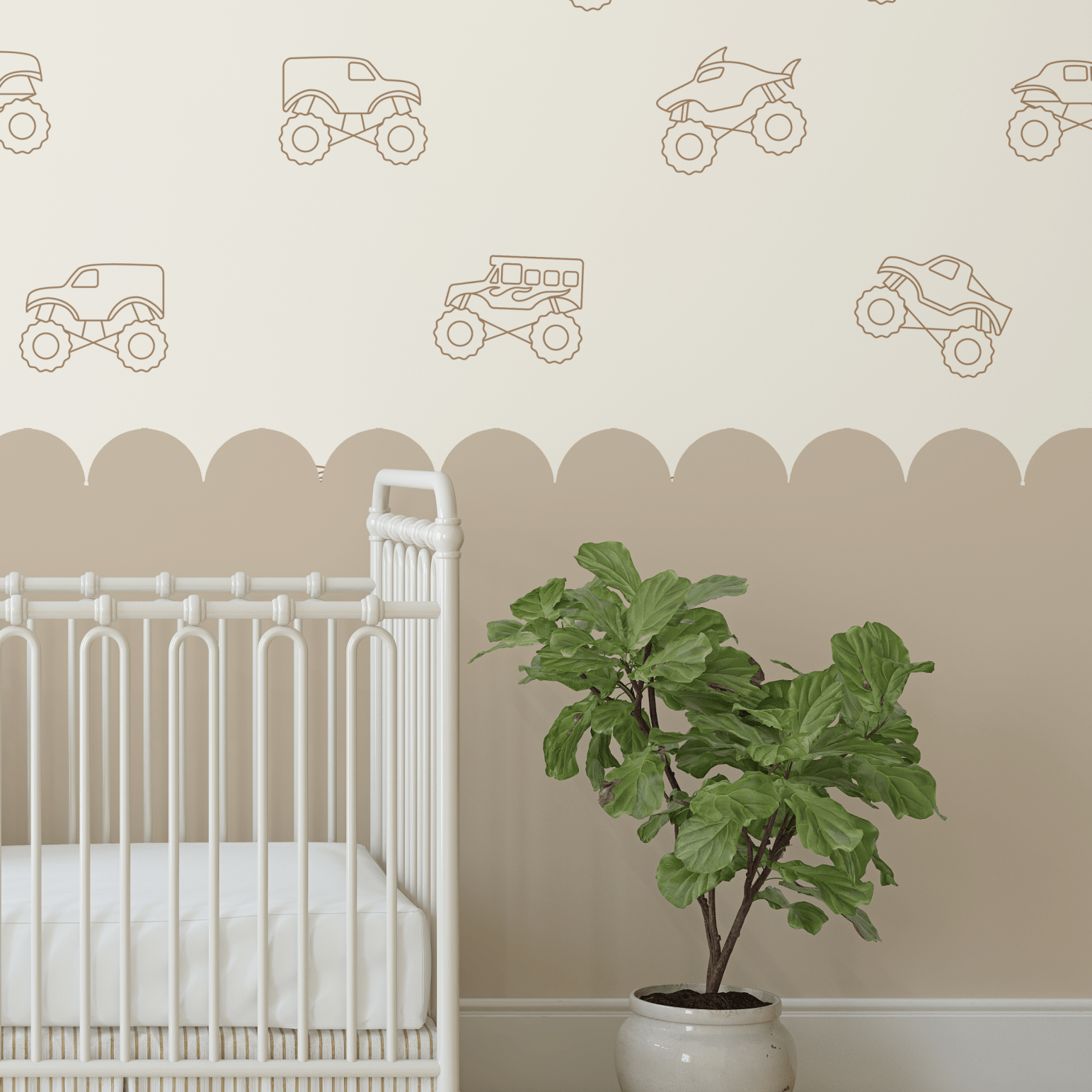 Detail of monster truck decals in brown outline on a neutral wall, paired with a white crib and a potted plant