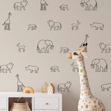Safari animal wall decals on taupe wall behind neutral nursery furniture
