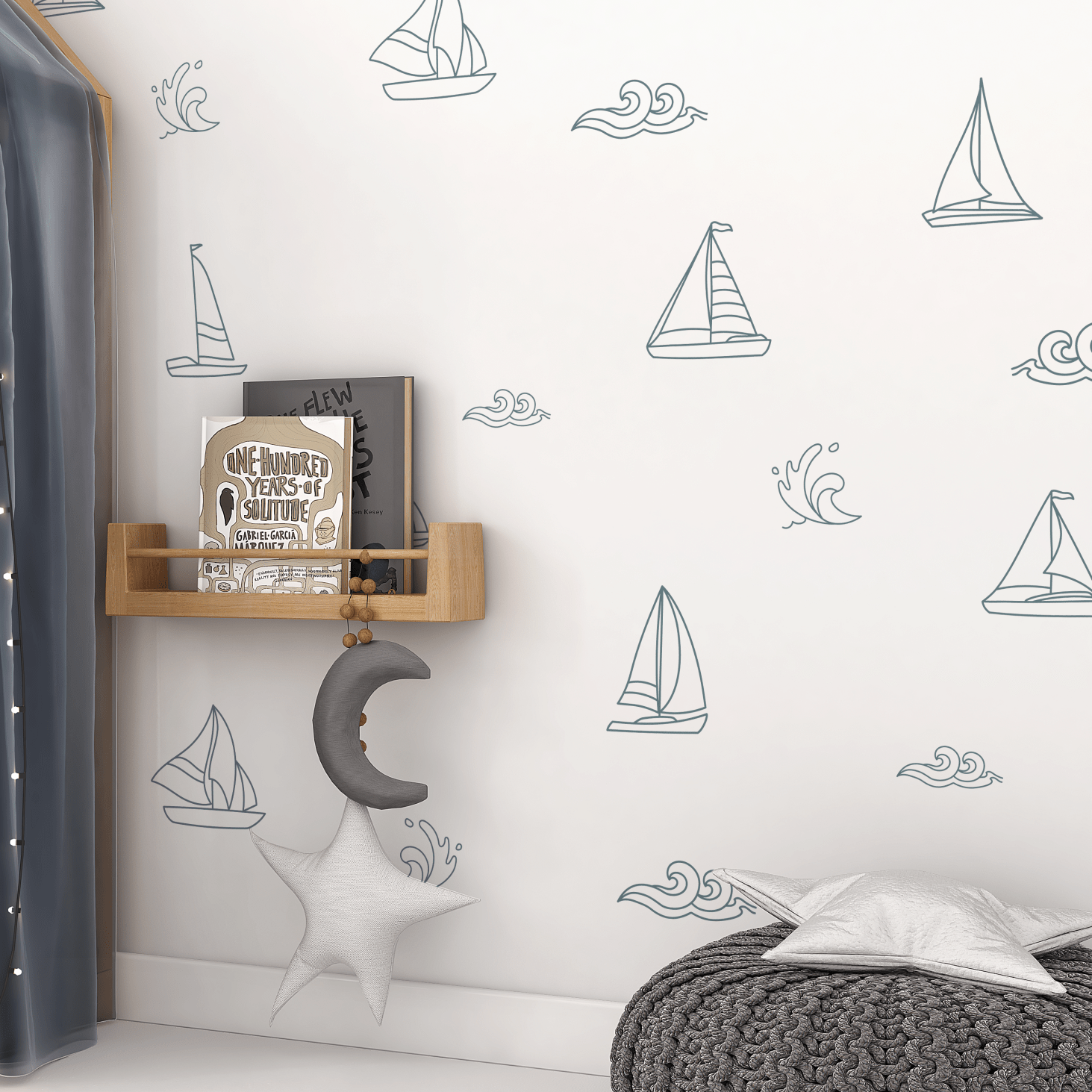 Sailboat and ocean wave wall decals in a cozy reading nook with a moon and star mobile