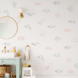 Kids' bathroom decorated with colorful underwater-themed decals, including fish, turtles, and starfish, creating a fun and vibrant sea-inspired design.