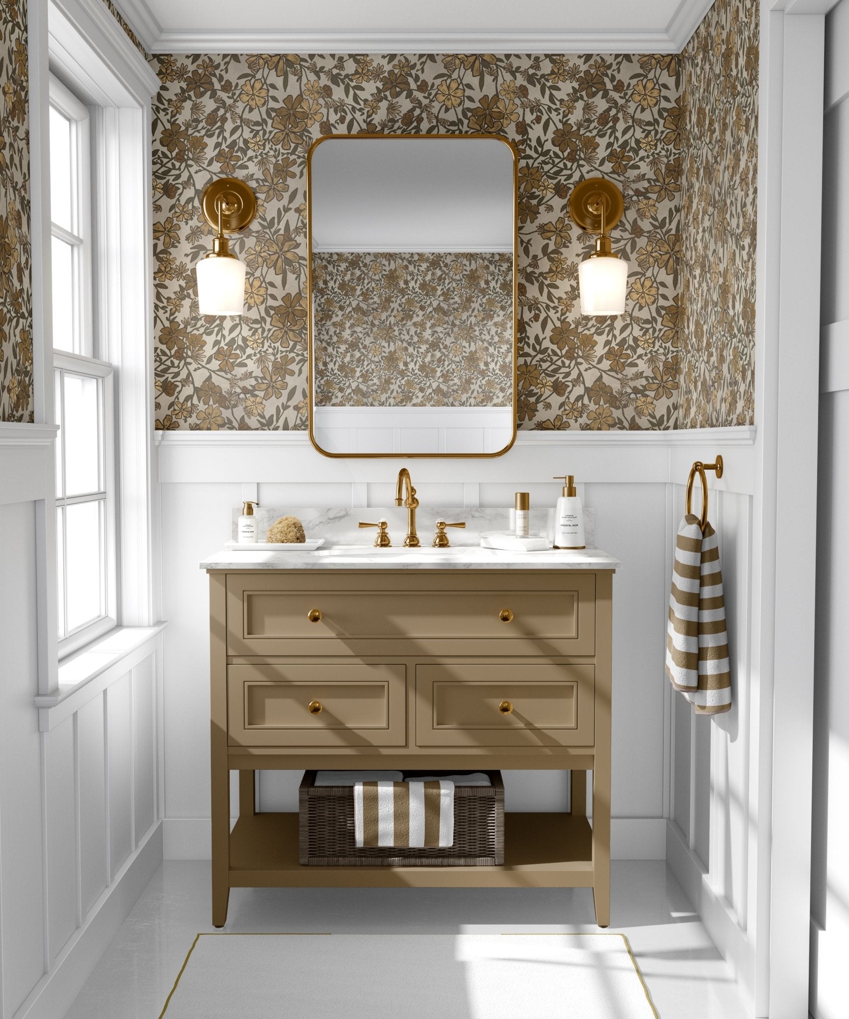 A stylish bathroom with white wainscoting featuring a floral wallpaper with brown and olive green flowers on a beige backdrop, complementing the gold-framed mirror and fixtures.
