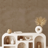 Elegant boho console table styled with Brown Tuscany Limewash Wallpaper in the background.