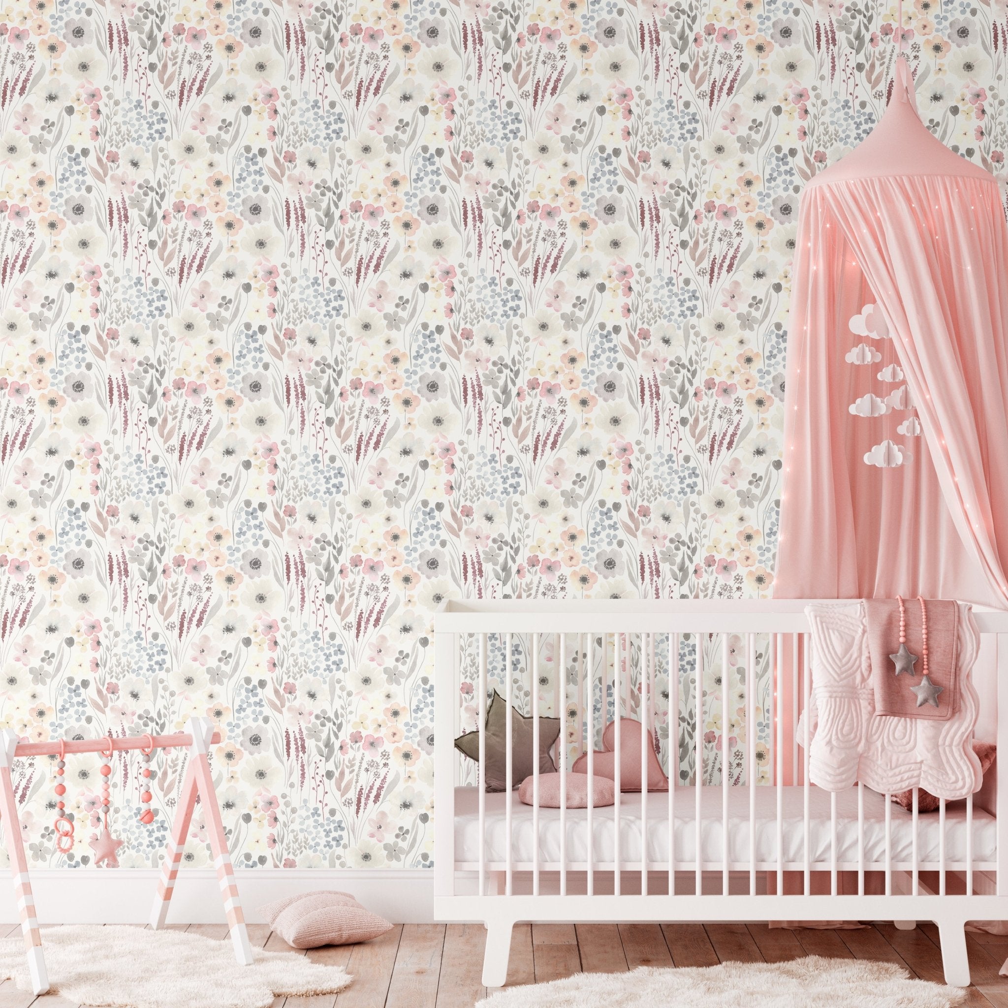 nursery decorated with the Vintage Anemones peel and stick wallpaper, featuring a crib, pink canopy, and playful pastel accents, highlighting the soft floral pattern on the walls